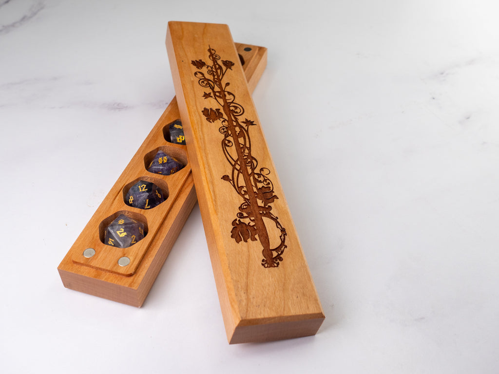 Wooden dice tray with engraved design on a white background