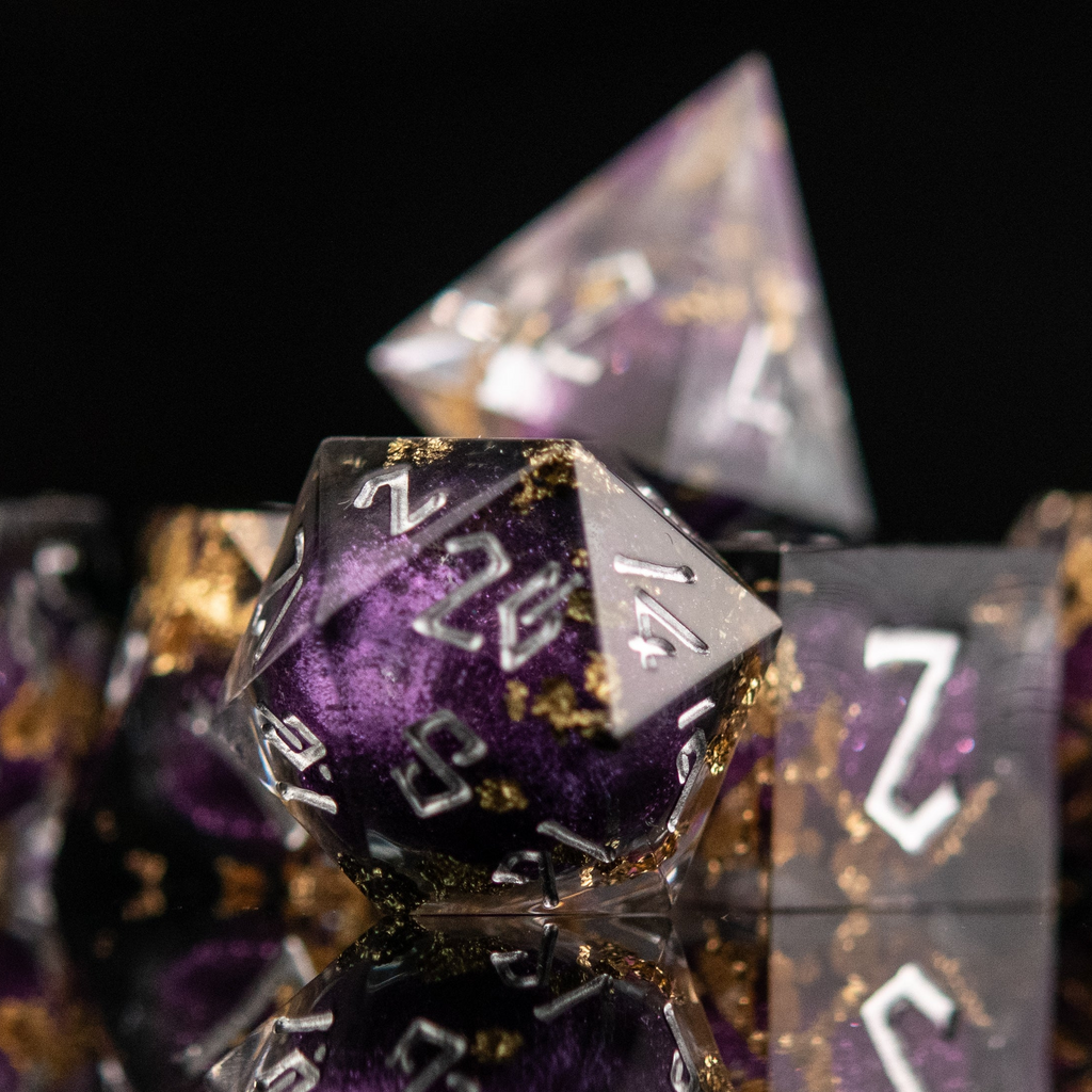 Close-up of purple and gold polyhedral dice 