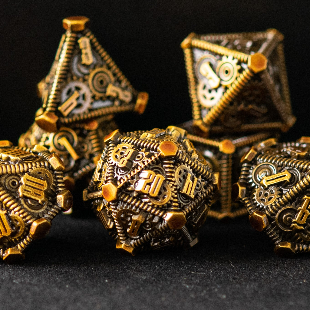 A set of brass metal dice with embossed numbers and gears for a steampunk inspired style for dnd