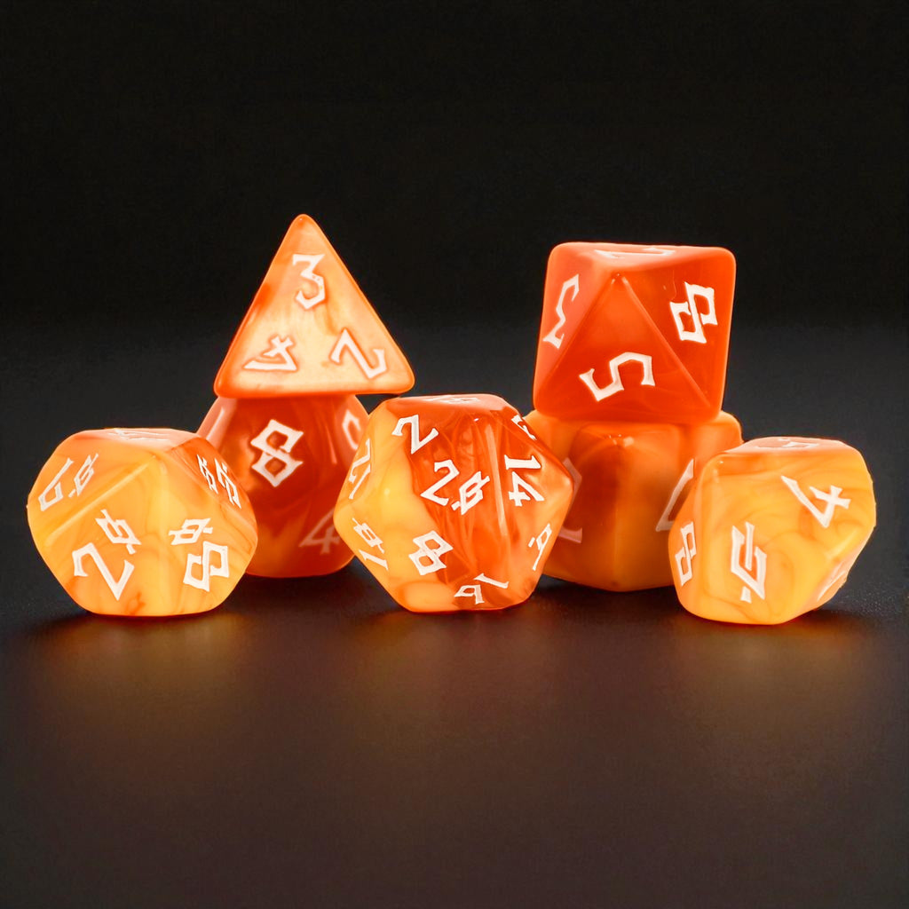 A set of orange and yellow creamy swirl colored acrylic ttrpg dnd dice with white numbers for tabletop gaming and board games