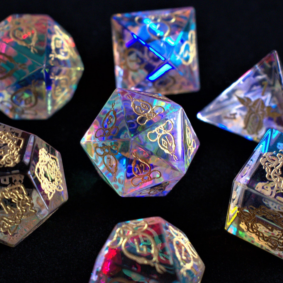 A set of hand-carved, iridescent prism glass dnd dice with engraved numbers, including a D4, D6, D8, two D10s, D12, and D20.