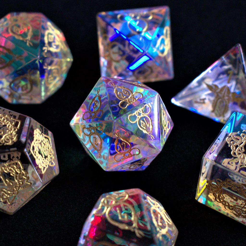 A set of hand-carved, iridescent prism glass dnd dice with engraved numbers, including a D4, D6, D8, two D10s, D12, and D20.