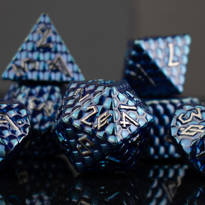 Blue polyhedral dice set with metallic text on a dark background