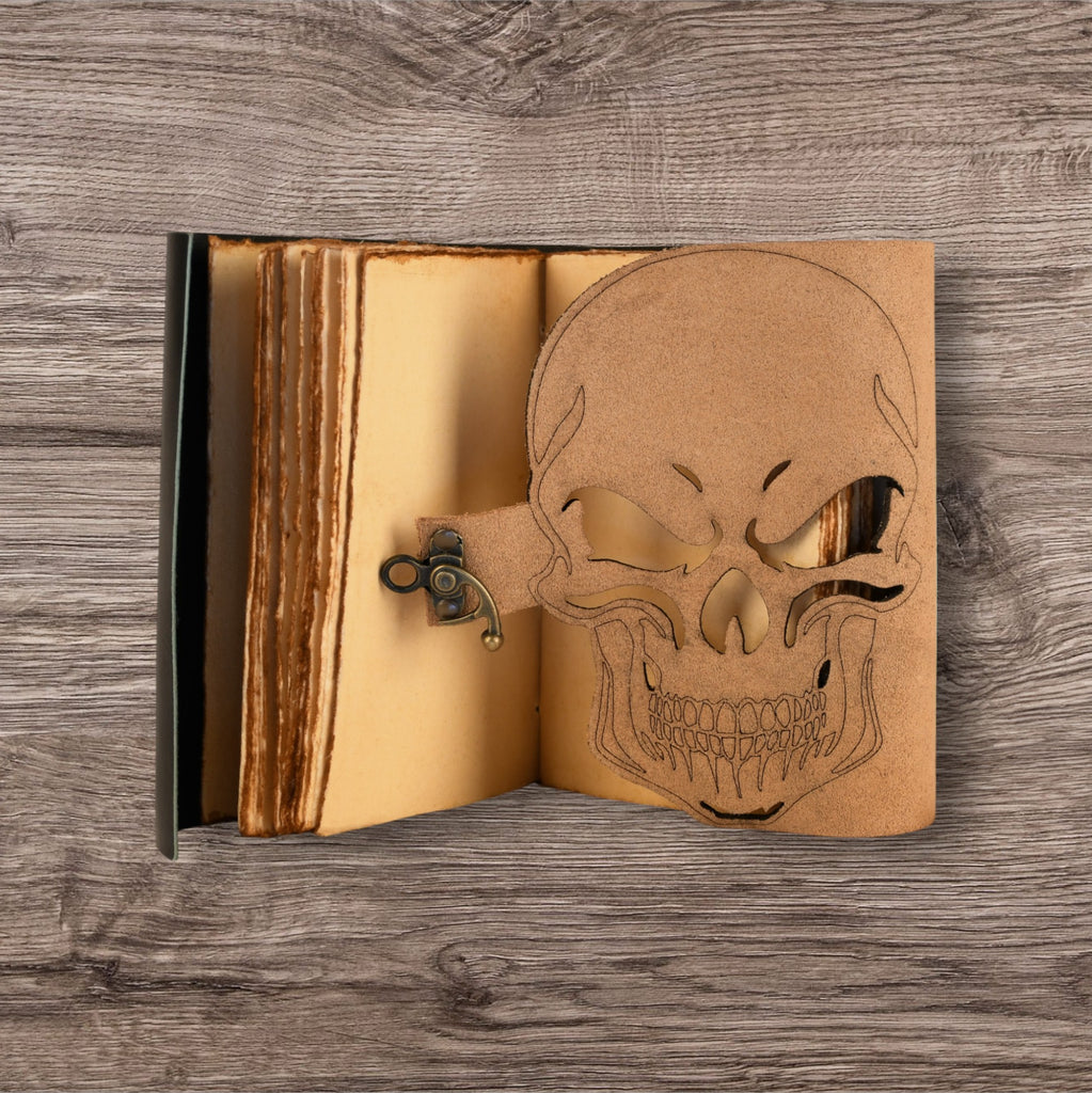 A leatherbound adventure journal with a skull design on the cover, featuring a brass buckle.