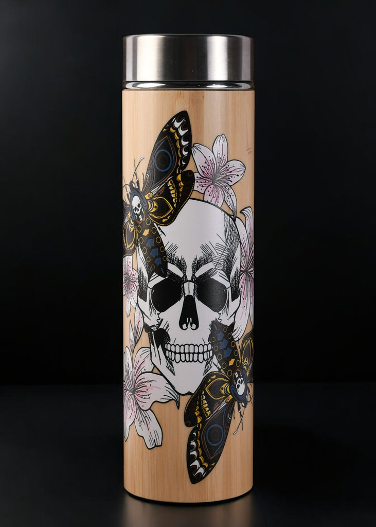 A stainless steel tea thermos with a graphic design of a skull, butterflies, and floral elements on the side. The thermos is accompanied by a removable steeper and is shown with the lid off.