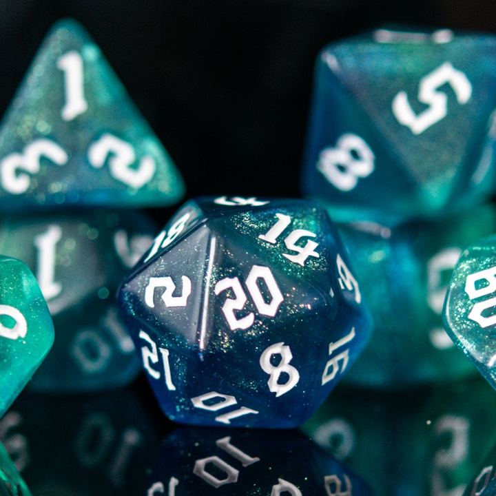 Close-up of a teal green polyhedral dice with numbers on a black background