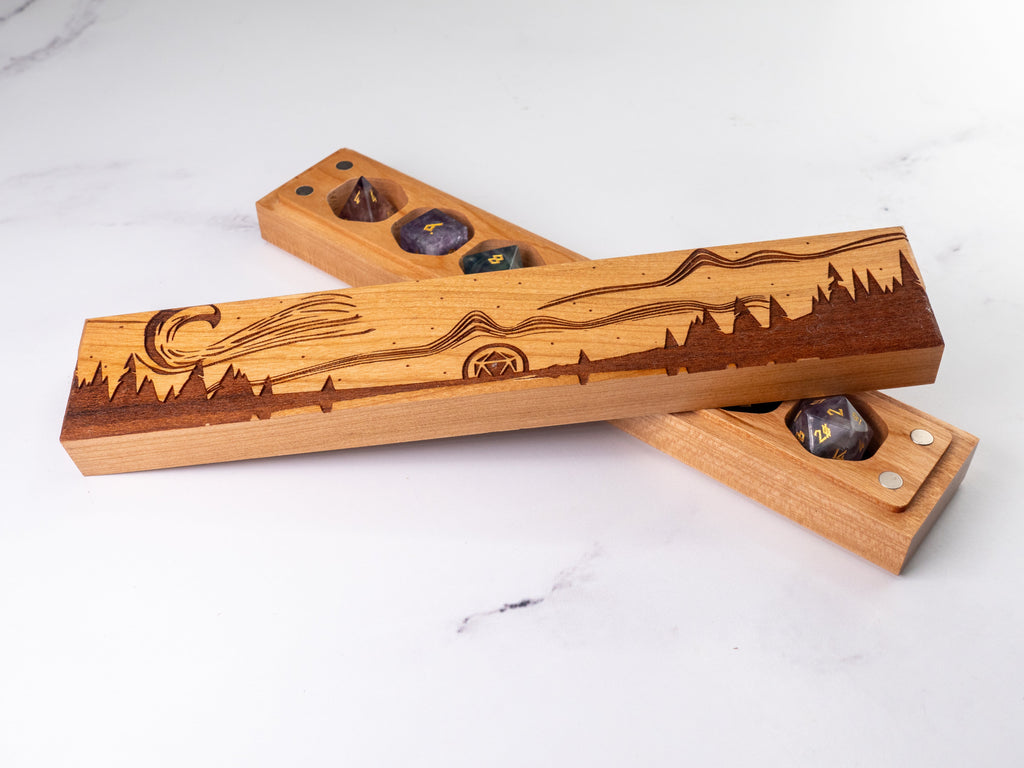 Wooden dice trays with laser-cut designs on a white surface
