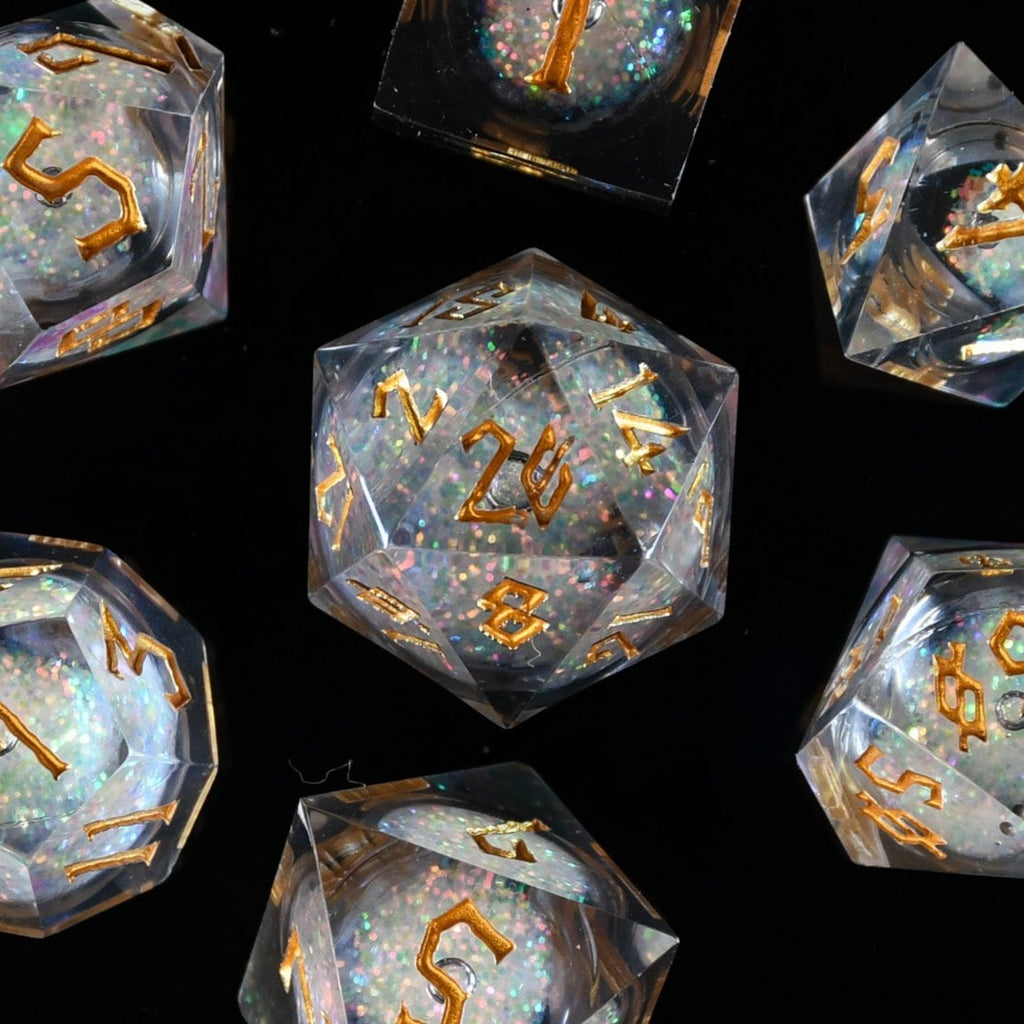 A set of resin liquid core dice with a liquid core, featuring floating glitter and engraved numbers, in various shapes including a d4, d6, d8, d10, d12, and d20.