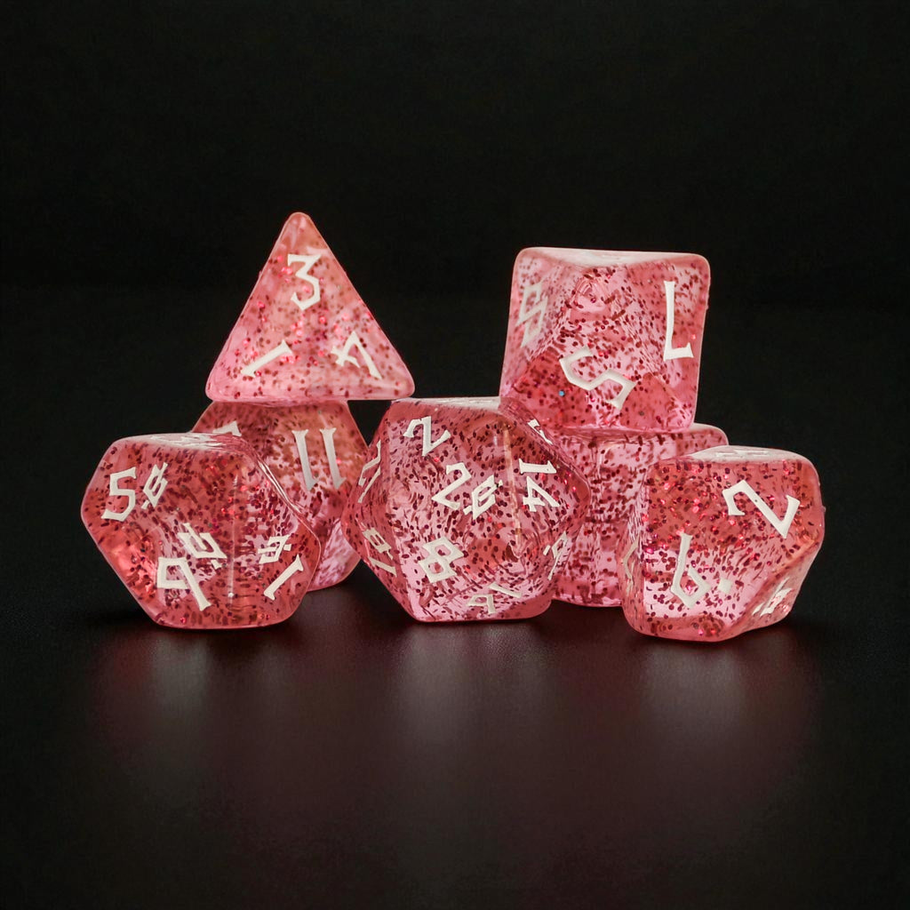 Pink acrylic dice set with glitter inside and white numbers in a clear nordic style font