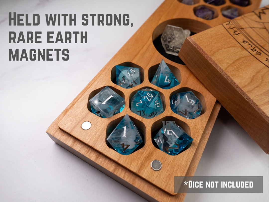 A wooden dice vault with an intricate etched design featuring an arcane summoning circle and various symbols, lying on a flat surface.