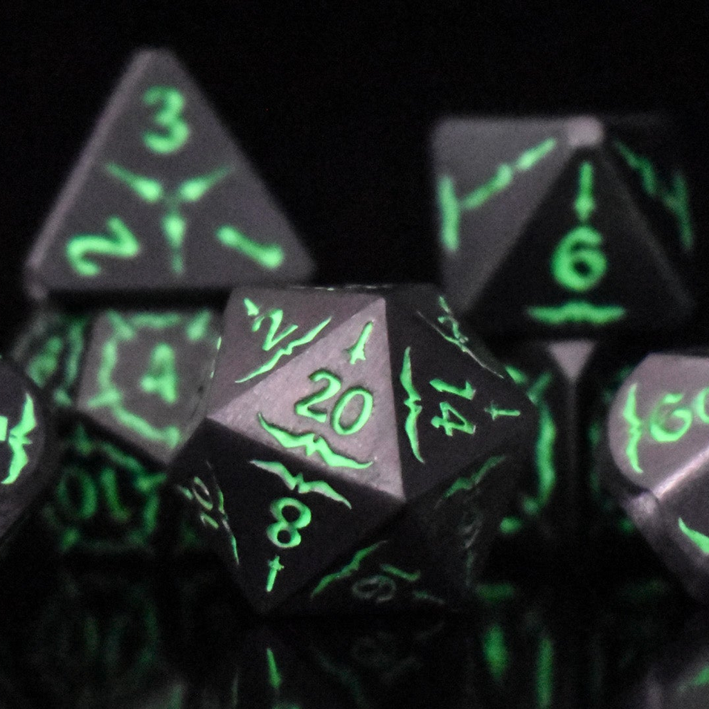 A set of glow-in-the-dark metal dnd dice with engraved numbers and swords, including various shapes such as a d4, d6, d8, d10, d12, and d20, displayed on a black background.