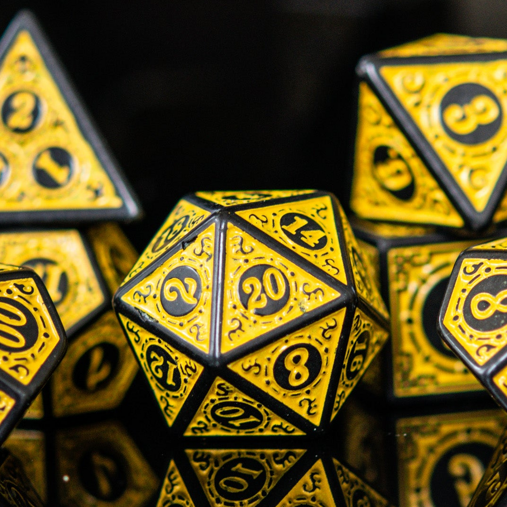 A set of yellow acrylic dice with black engravings, including various shapes such as a 4-sided, 6-sided, 8-sided, 10-sided, 12-sided, and 20-sided die, displayed against a reflective background. 
