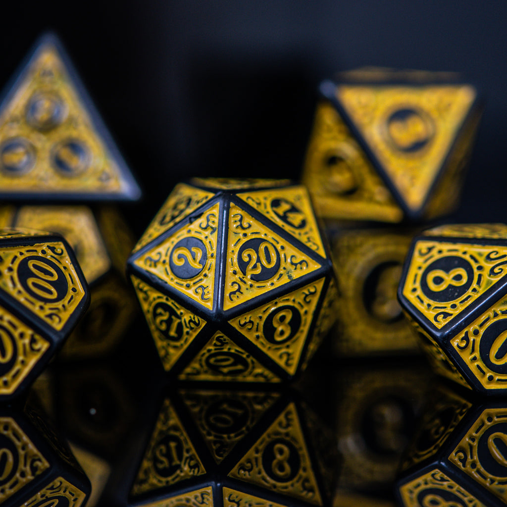 A set of yellow acrylic dnd dice with black engravings for playing tabletop roleplaying games, wargaming and board games
