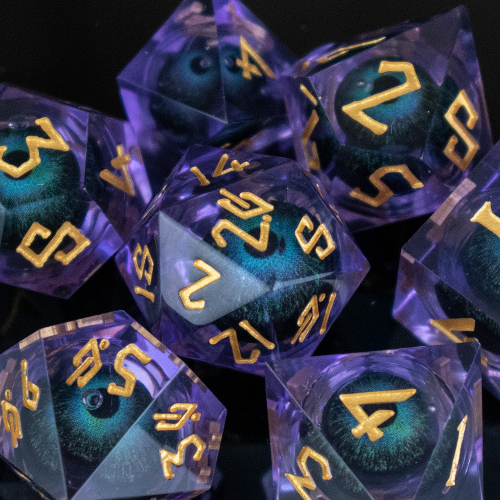 Translucent dice with blue and purple hues and gold numbering on a dark background