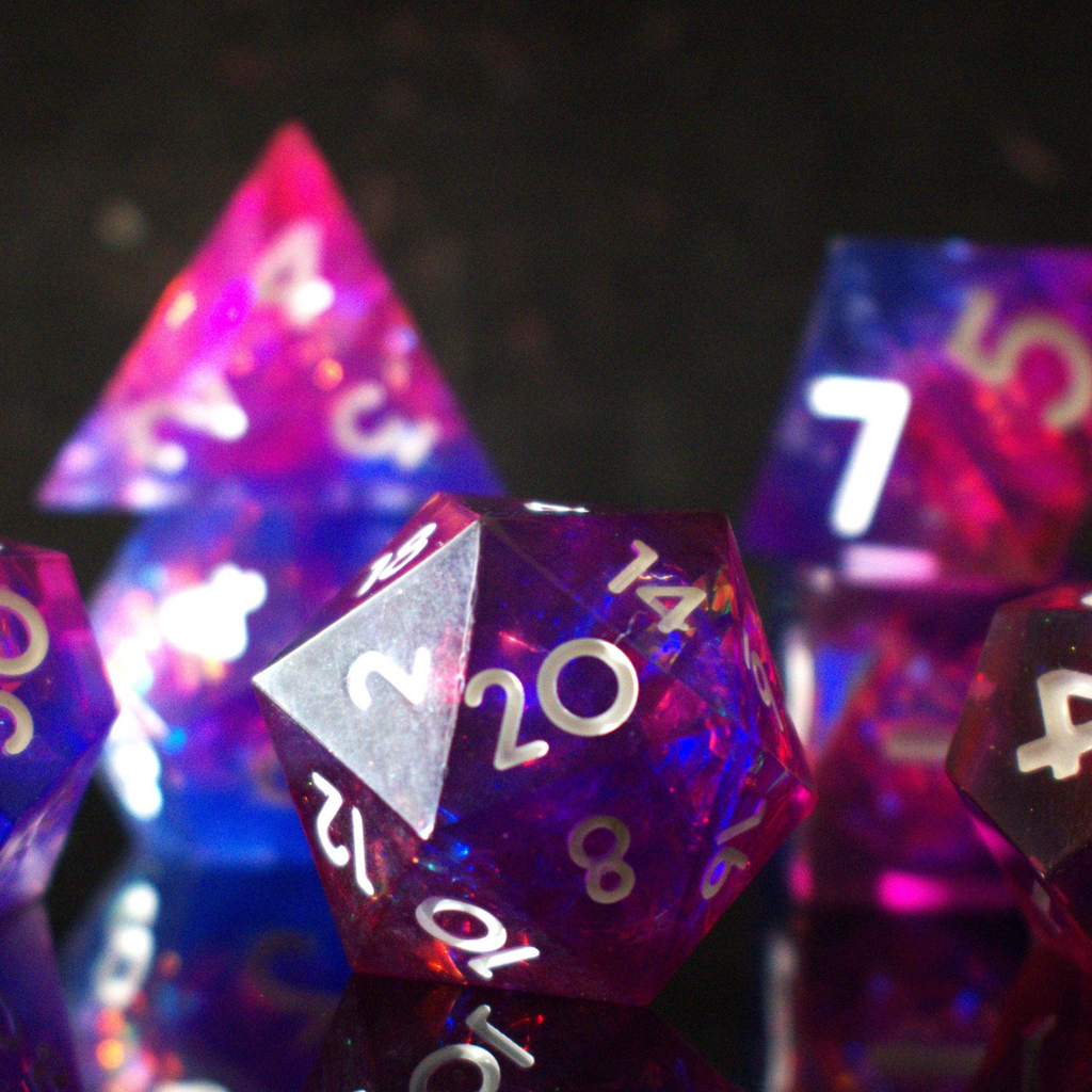 A set of sharp-edged resin dice in pink and purple colors with engraved white numbers, reflecting on a shiny surface.