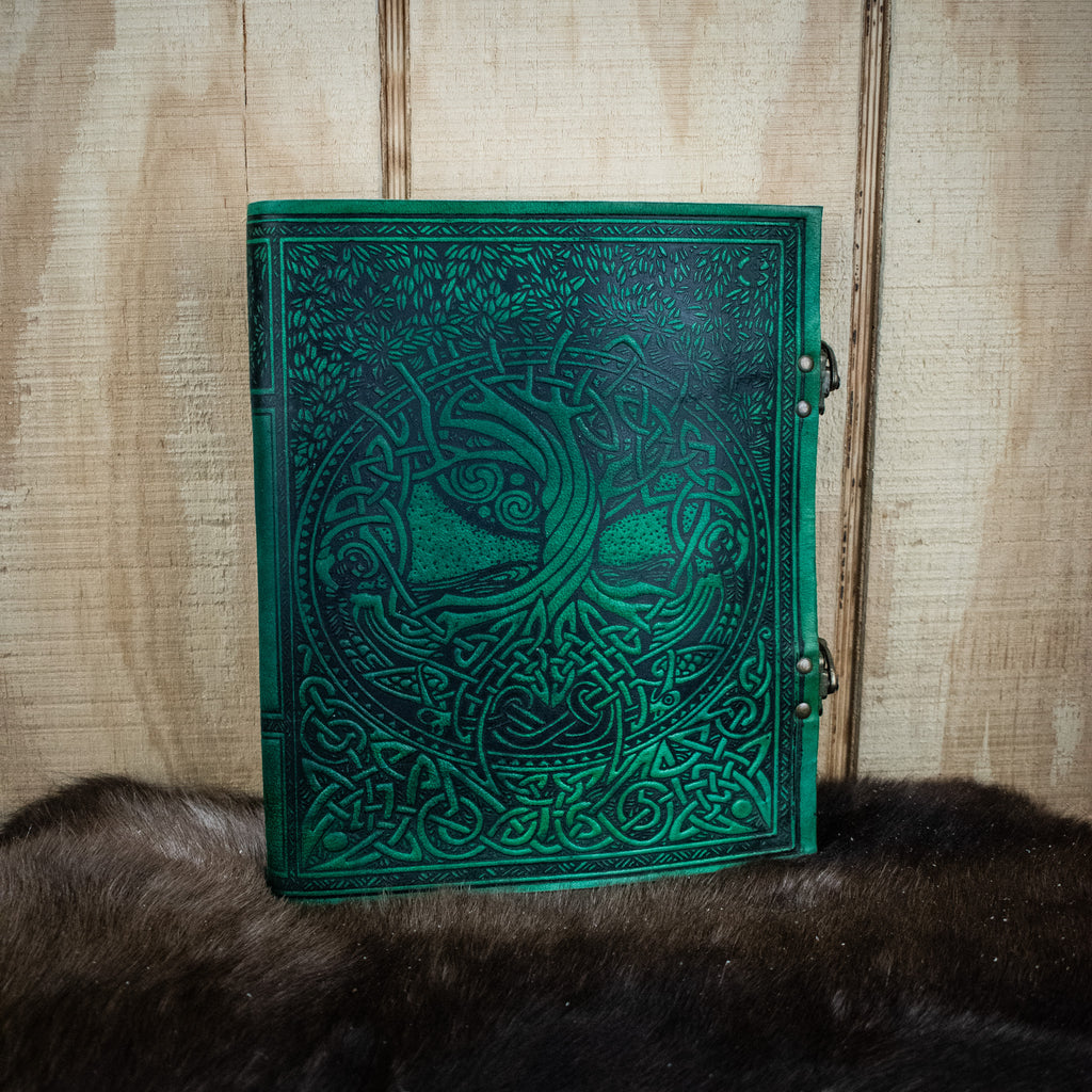 A green leather sketchbook featuring the tree of life