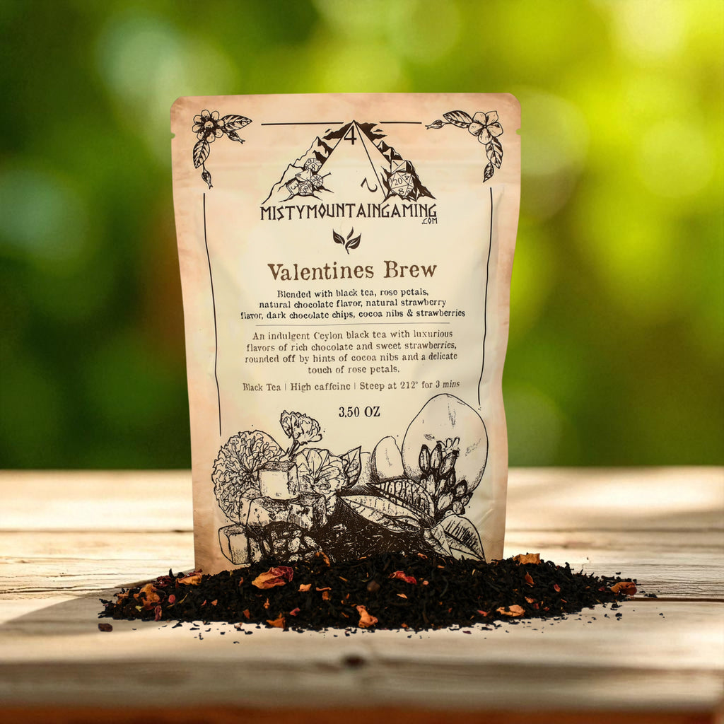 Tea bag labeled 'Valentines Brew' from Misty Mountain Gaming on a wooden surface with loose tea leaves.