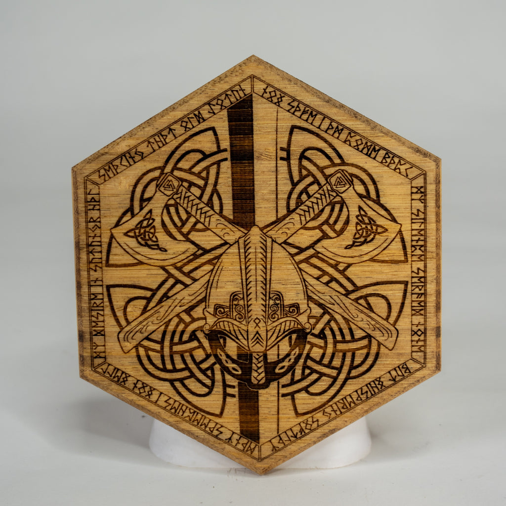 Wooden hexagonal puck with intricate viking carvings on a white background