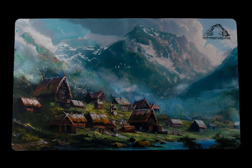 A playmat featuring an illustration of a Viking village with a mountainous backdrop.