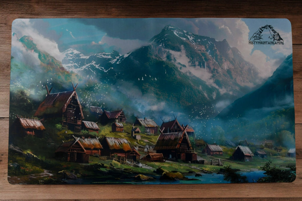A playmat featuring an illustration of a Viking village with a mountainous backdrop.
