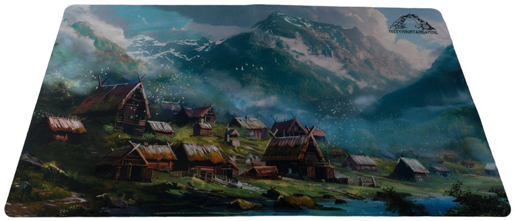 A playmat featuring an illustration of a Viking village with a mountainous backdrop.