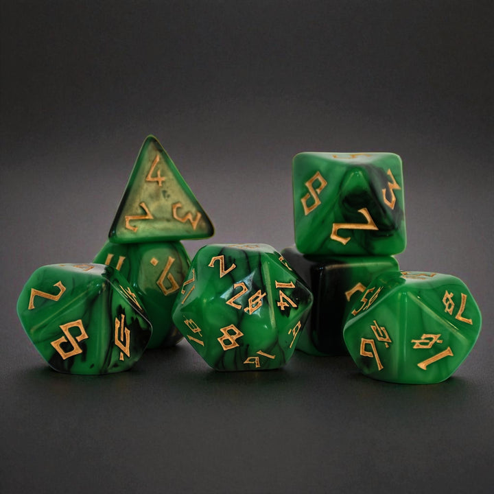 a set of green acrylic dice with black swirls and gold numbering for gaming