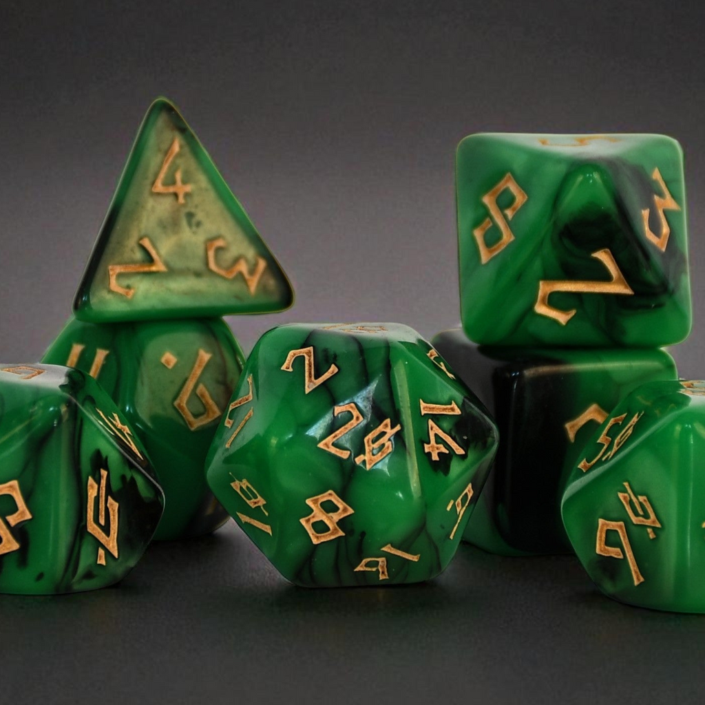 Set of green polyhedral dice with gold numbers on a dark background