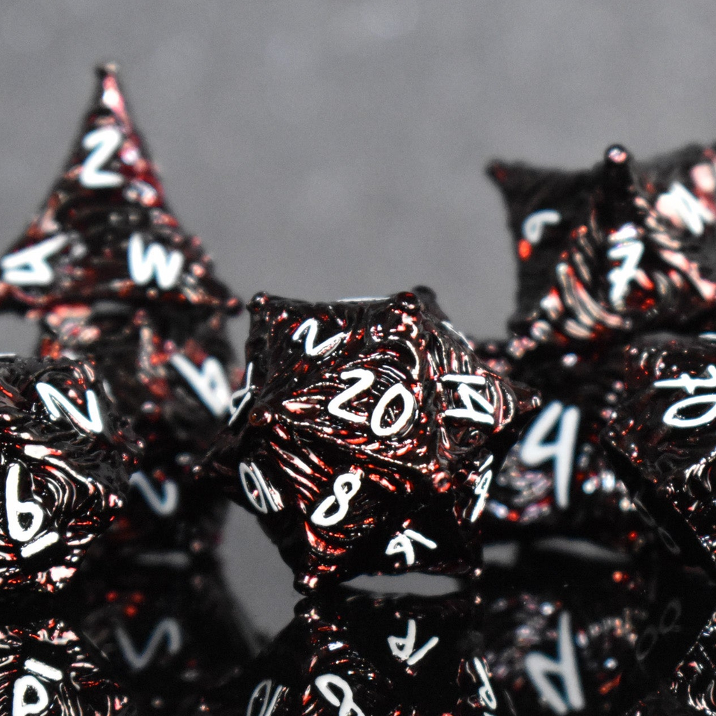 Black dice with white numbers and letters on a gray background