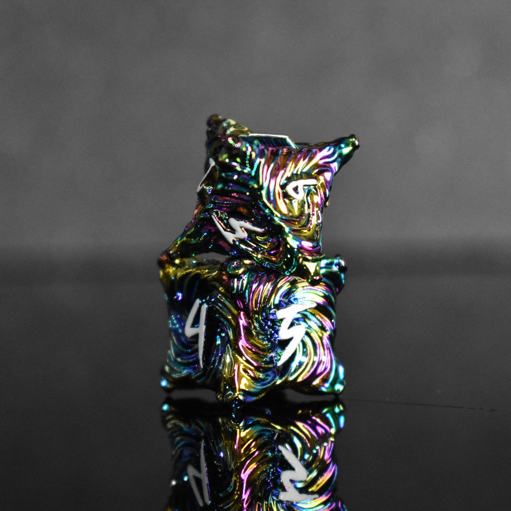 Iridescent metal dice with vortex swirls and a white font