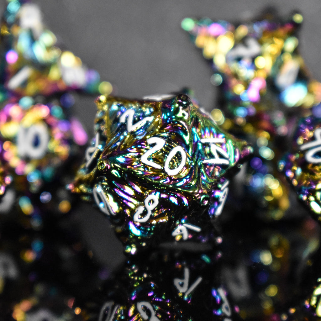 Iridescent metal dice with vortex swirls and a white font