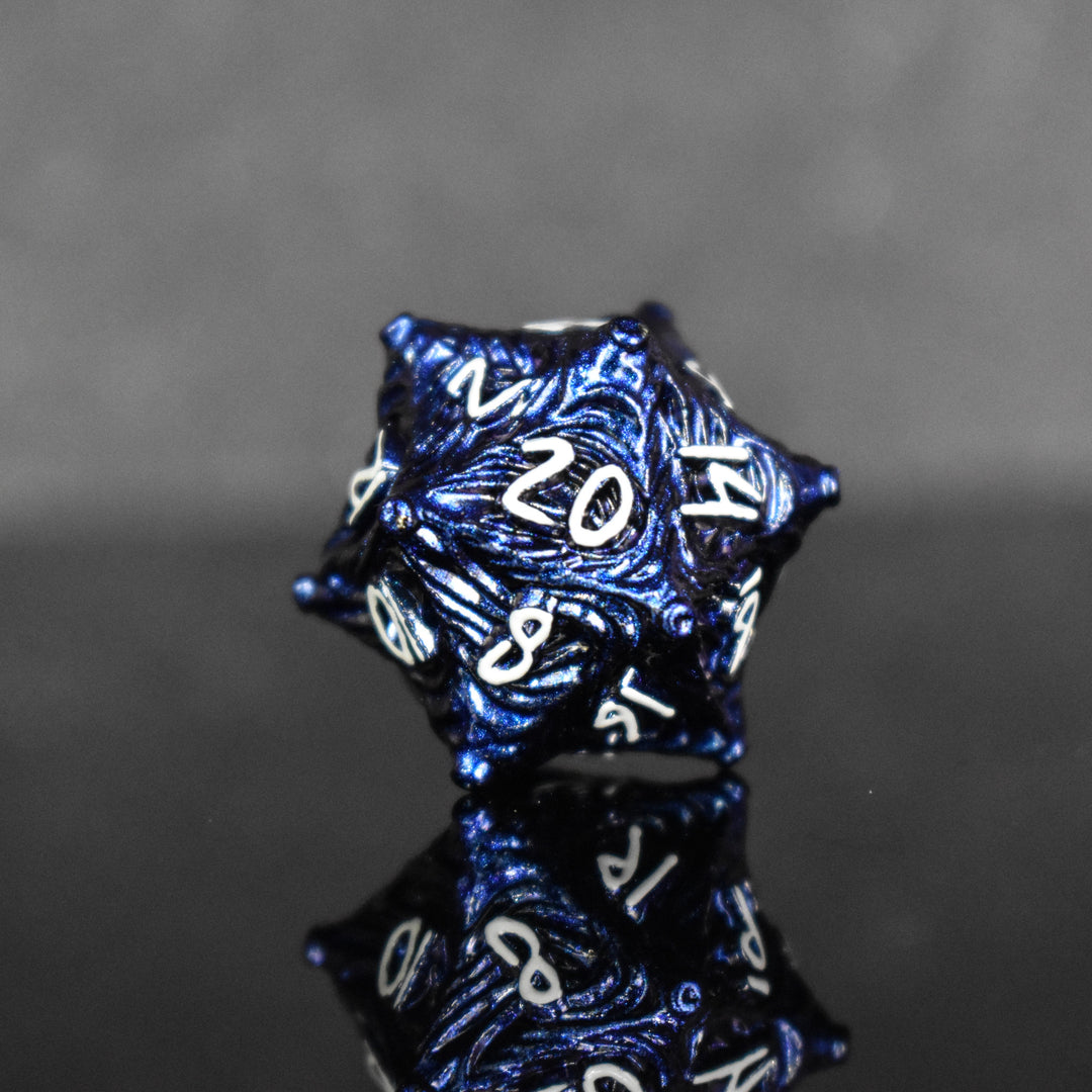 Dark blue metal D20 with vortex swirls and a white font