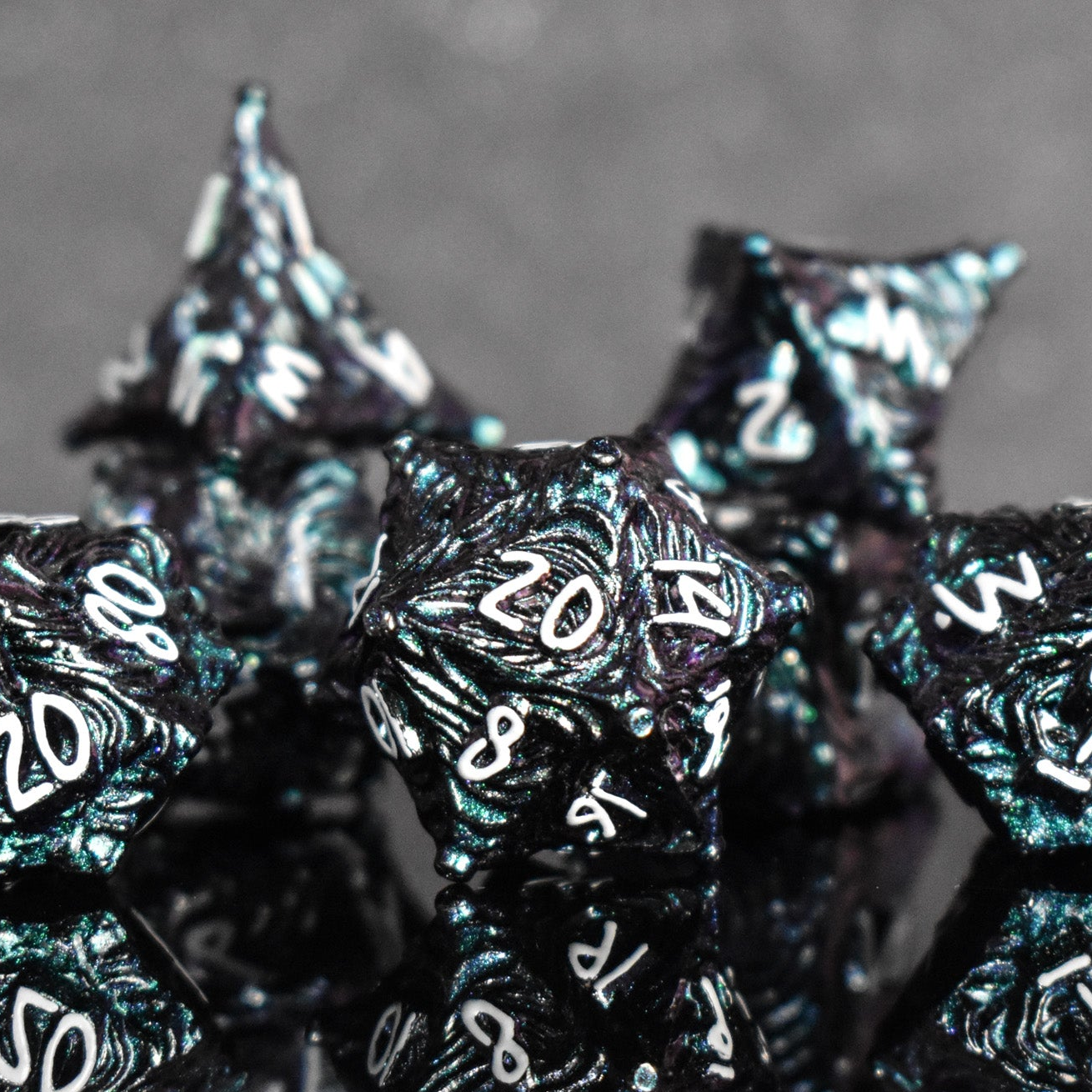 Iridescent galaxy vortex metal dice featuring white font numbers