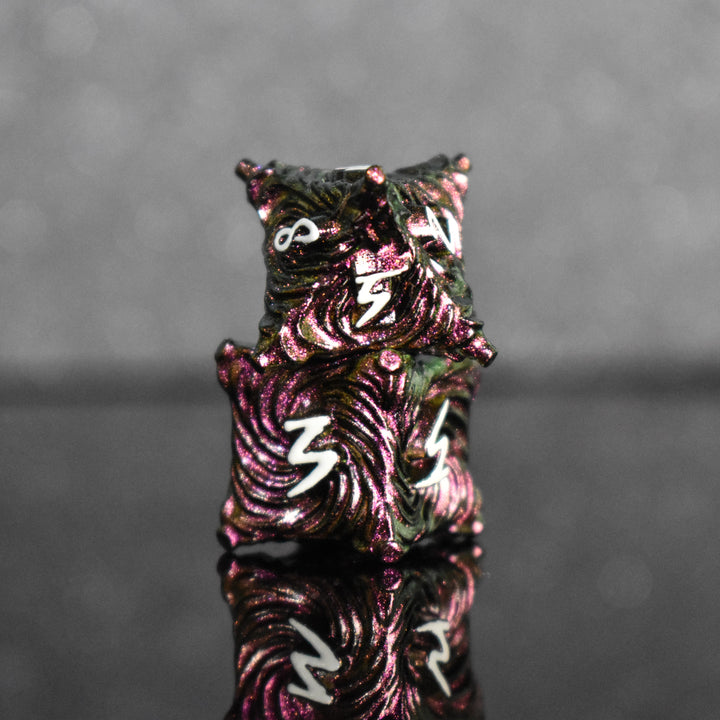 Pearlescent magenta metal vortex dice with white font numbers