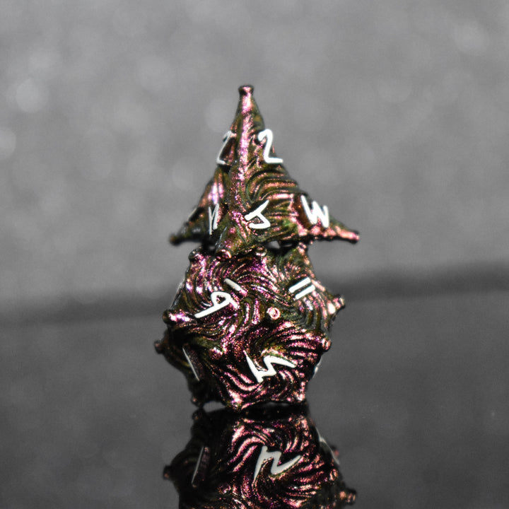 Pearlescent magenta metal vortex dice with white font numbers
