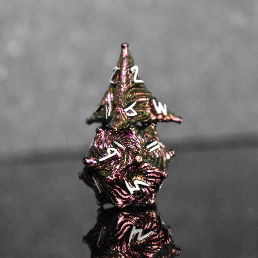 Pearlescent magenta metal vortex dice with white font numbers