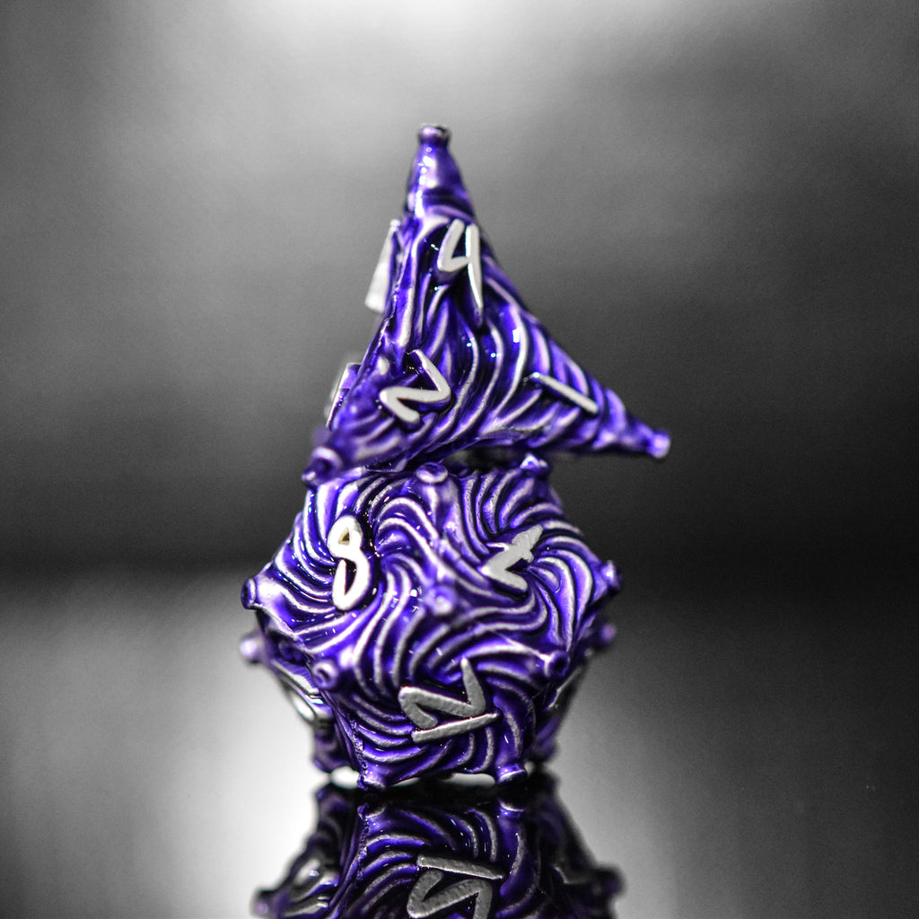 Purple metal vortex dice featuring silver font numbers