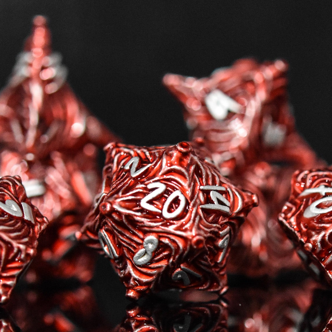 Close-up of red polyhedral dice with white numbers on a black background