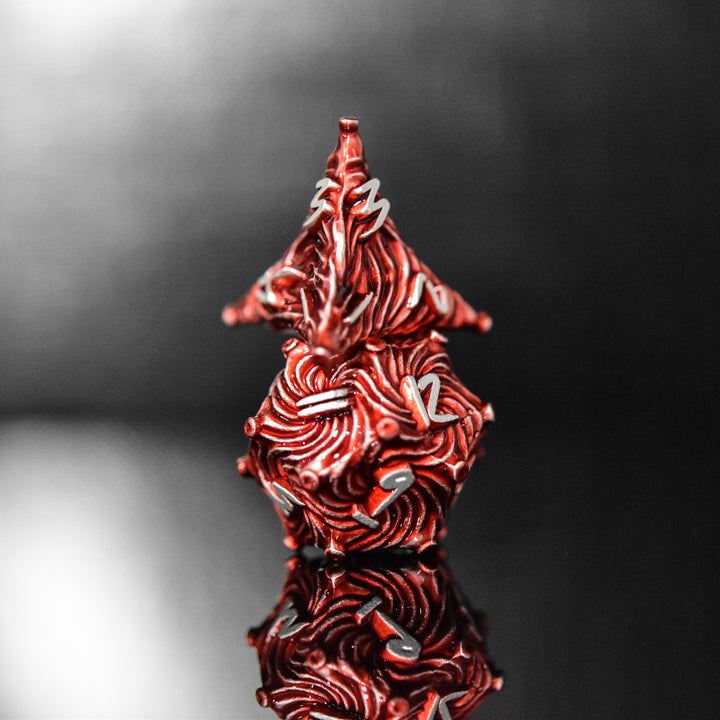 Red metal vortex dice featuring silver font numbers