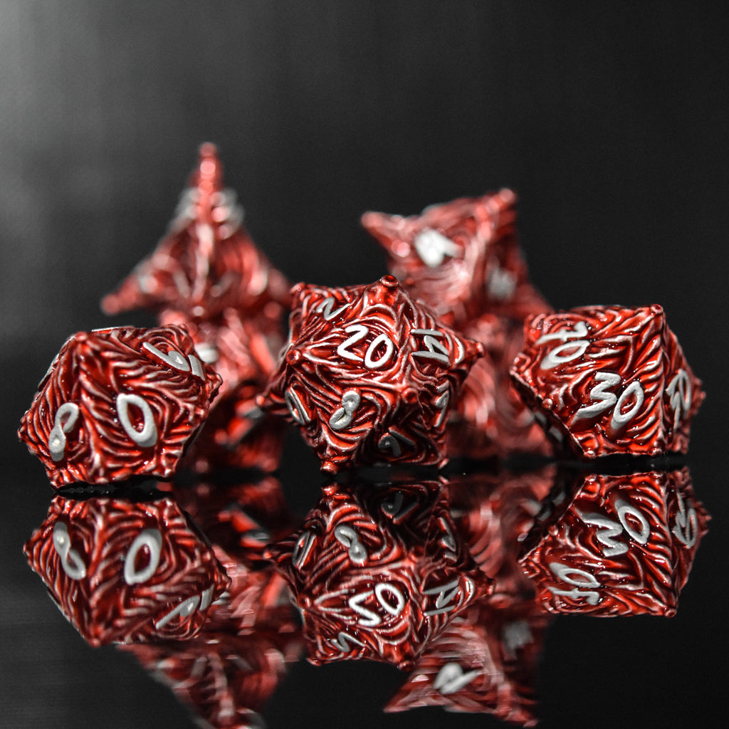 Red metal vortex dice featuring silver font numbers