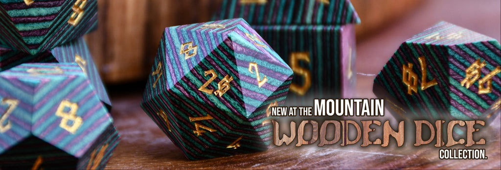 Wooden dice with intricate designs and numbering, displayed on a wooden surface with promotional text.