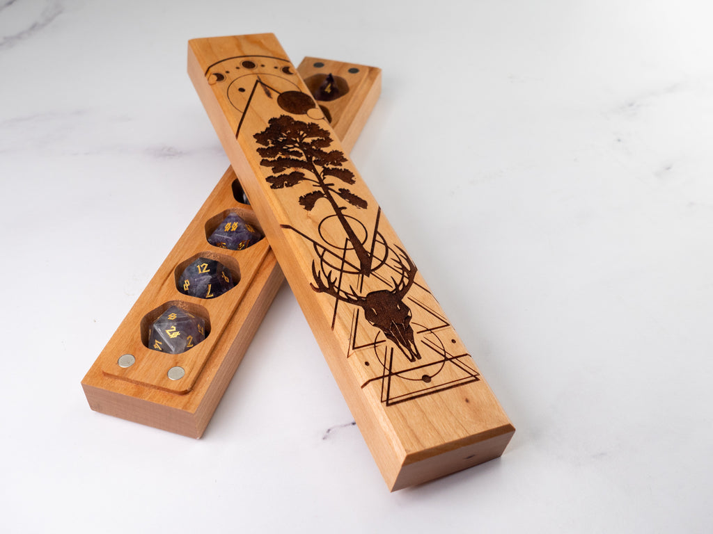 Wooden dice trays with laser-cut designs on a white background
