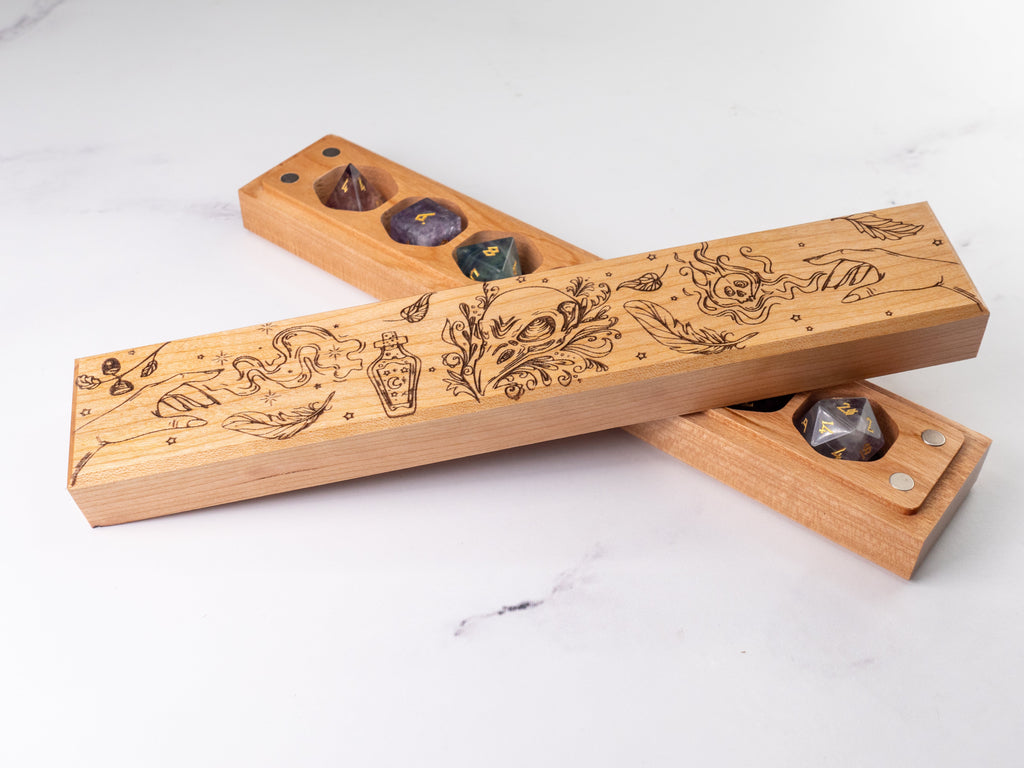 Wooden dice tray with engraved designs on a white surface