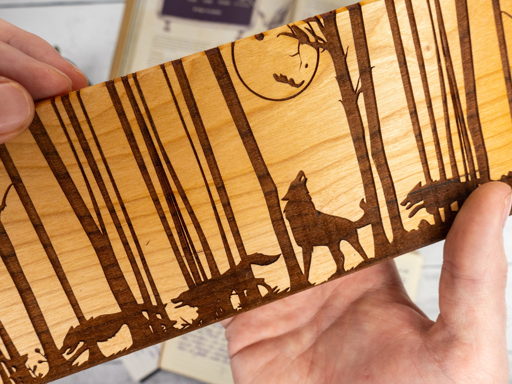 engraved wooden dice vault with wolves howling at the moon