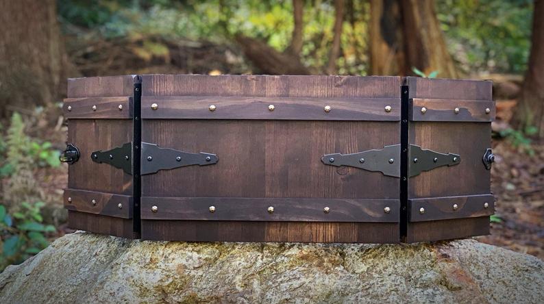 A dark stained wooden dungeon master screen