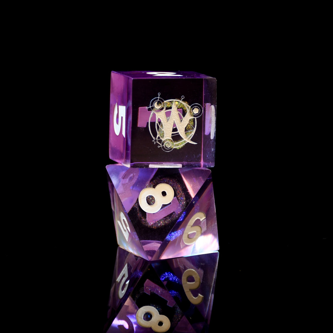 Purple polyhedral dice set with a logo on a black background