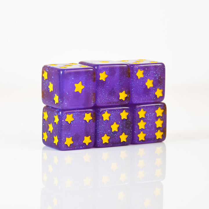 Purple dice with yellow star patterns stacked on a white background