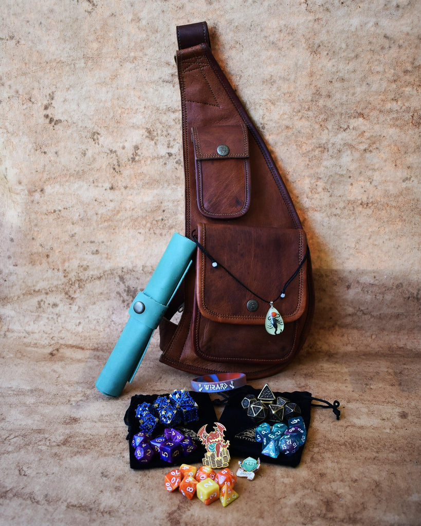 A brown leather sling mystery dice bag with examples of the items within