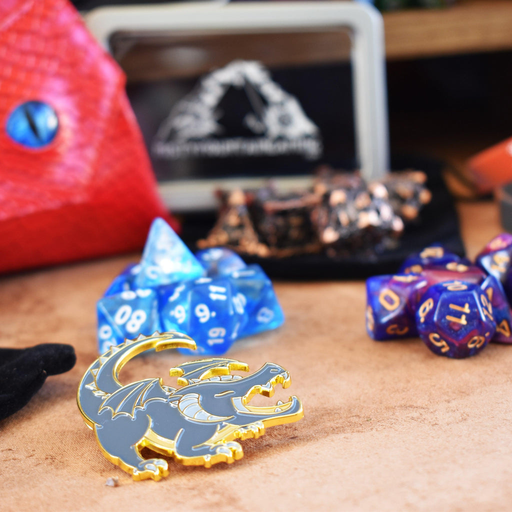 Sets of dice and a pin, examples of items within the mystery bundle