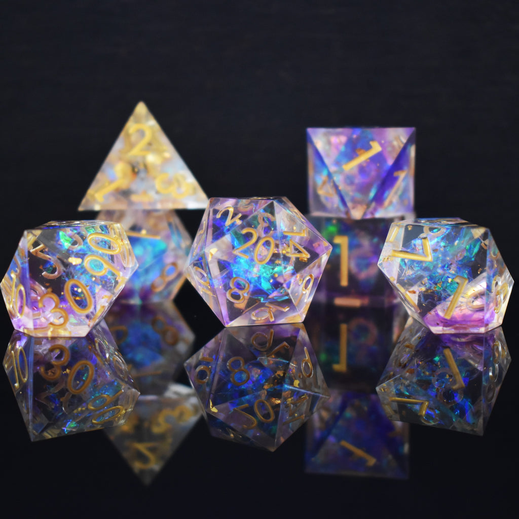 A set of clear sharp edge resin dnd dice with gold numbering and pastel neon iridescent foil inside for tabletop games and board games