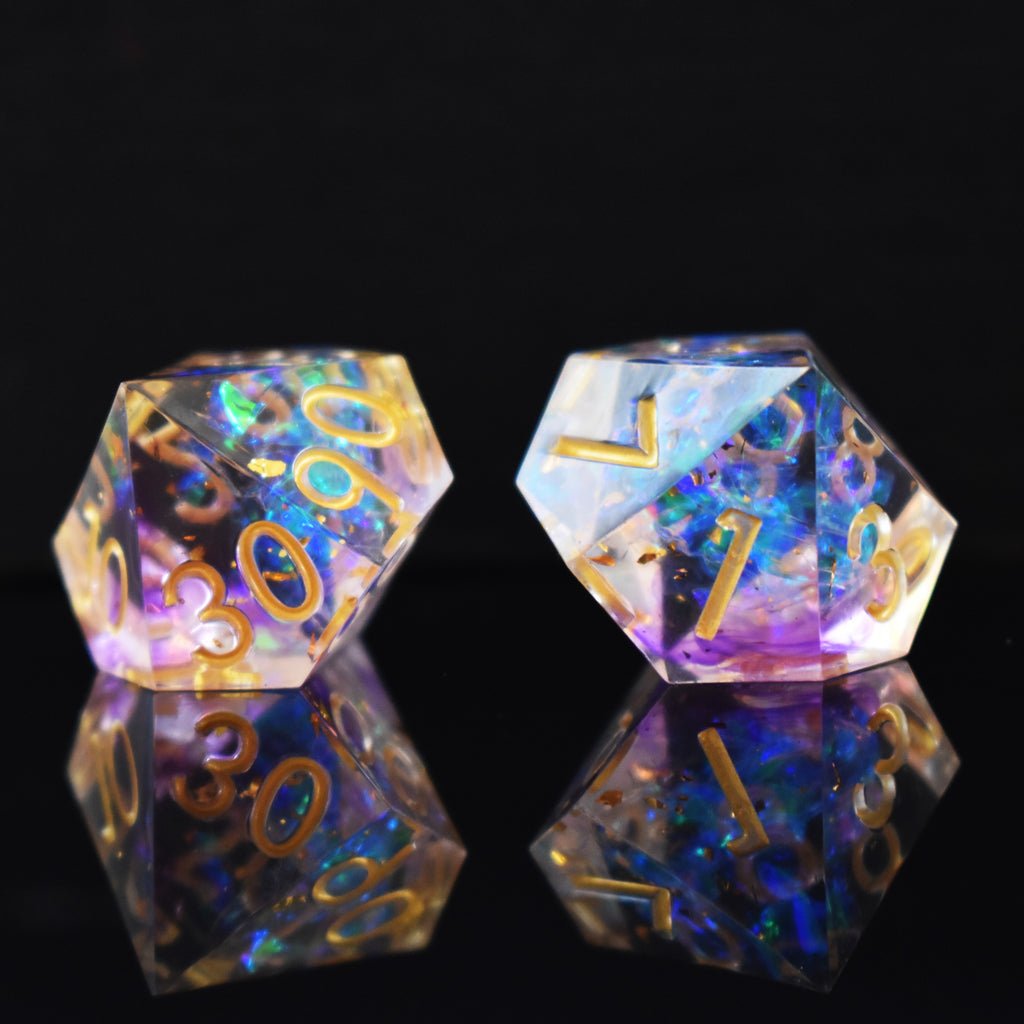 A set of clear sharp edge resin dnd dice with gold numbering and pastel neon iridescent foil inside for tabletop games and board games